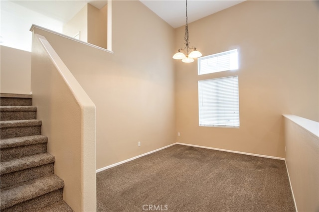 staircase with carpet flooring and an inviting chandelier