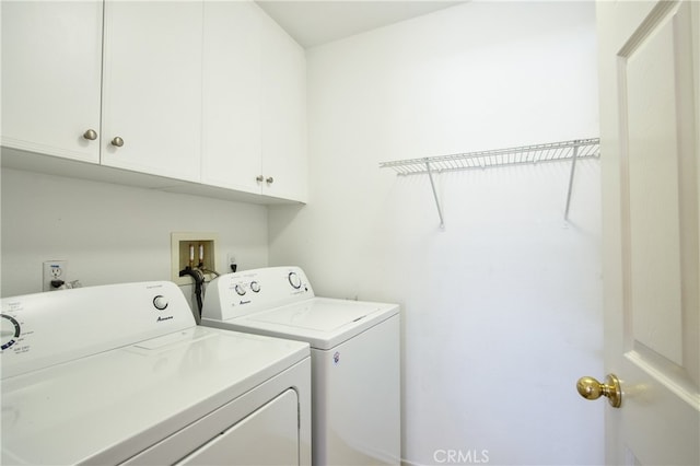 laundry area with cabinets and washing machine and clothes dryer