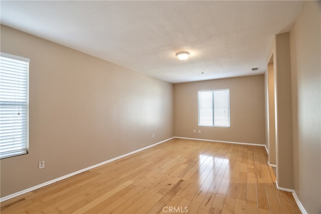 unfurnished room featuring light hardwood / wood-style floors