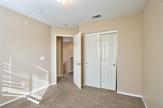 unfurnished bedroom featuring a closet and carpet floors