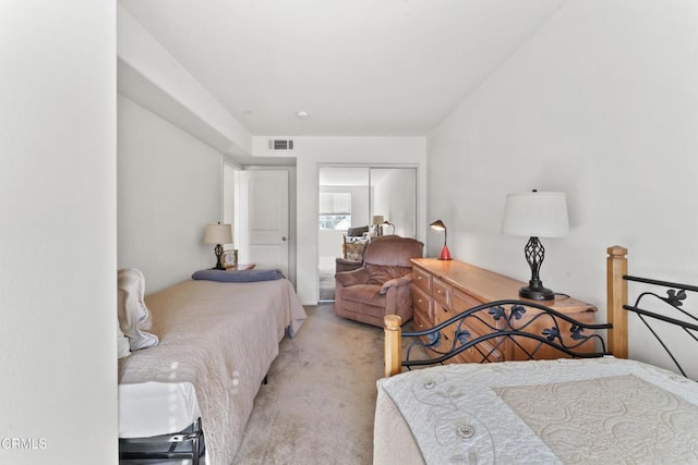 bedroom featuring light colored carpet and a closet