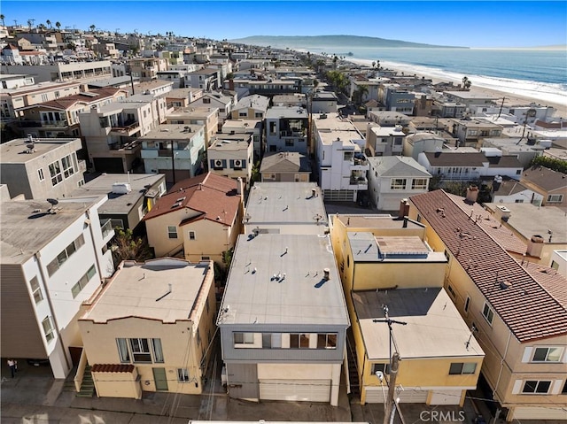 drone / aerial view with a beach view and a water view