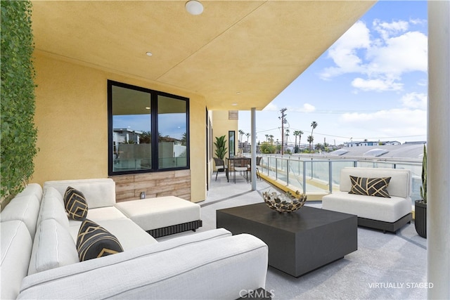 view of patio with a balcony and outdoor lounge area