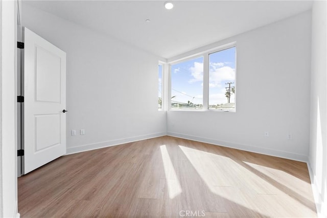 unfurnished room featuring light hardwood / wood-style floors