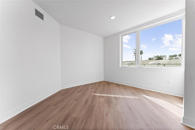 spare room featuring light hardwood / wood-style flooring