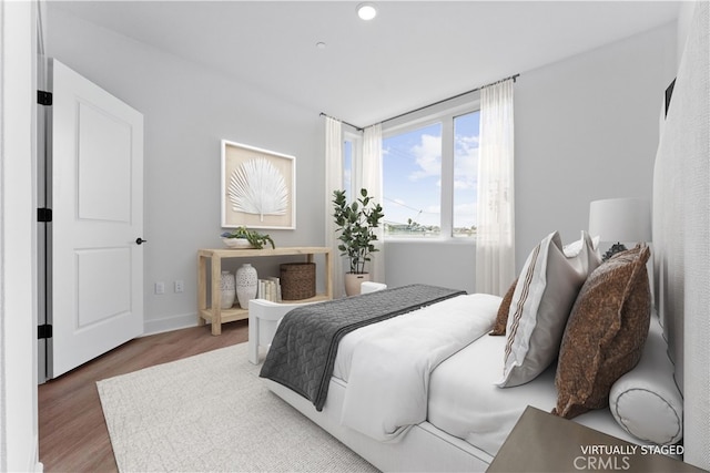 bedroom with dark wood-type flooring