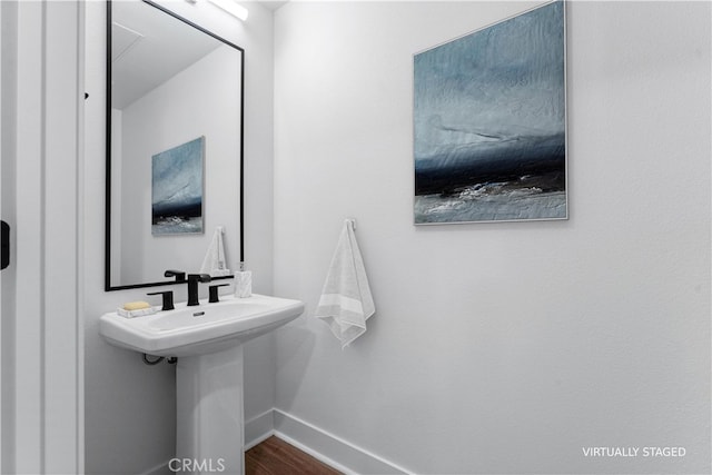 bathroom with sink and hardwood / wood-style floors