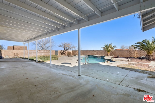 view of patio with a fenced in pool