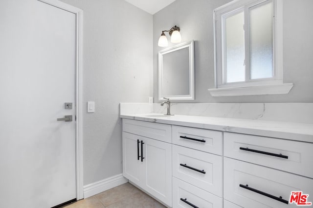 bathroom with vanity and tile patterned flooring