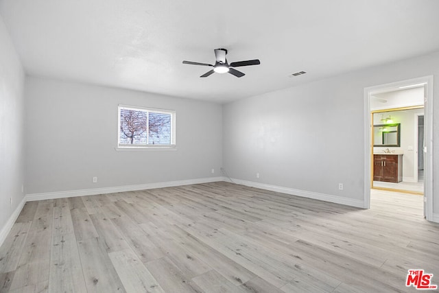 empty room with ceiling fan and light wood-type flooring