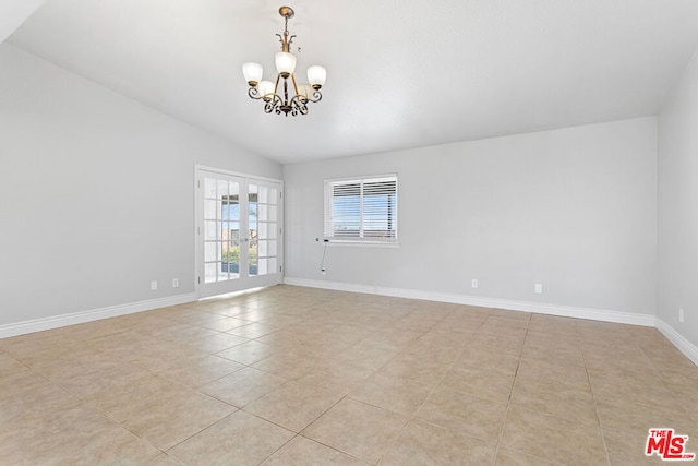 unfurnished room with french doors, vaulted ceiling, a chandelier, and light tile patterned flooring