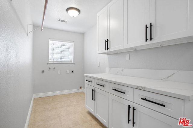 laundry room with cabinets, hookup for a gas dryer, hookup for a washing machine, and hookup for an electric dryer