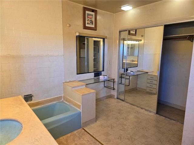 bathroom featuring a bathing tub and vanity