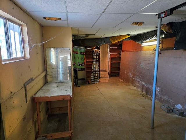 basement with a paneled ceiling