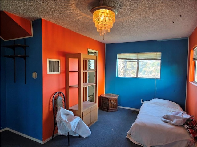 carpeted bedroom featuring a textured ceiling and an inviting chandelier