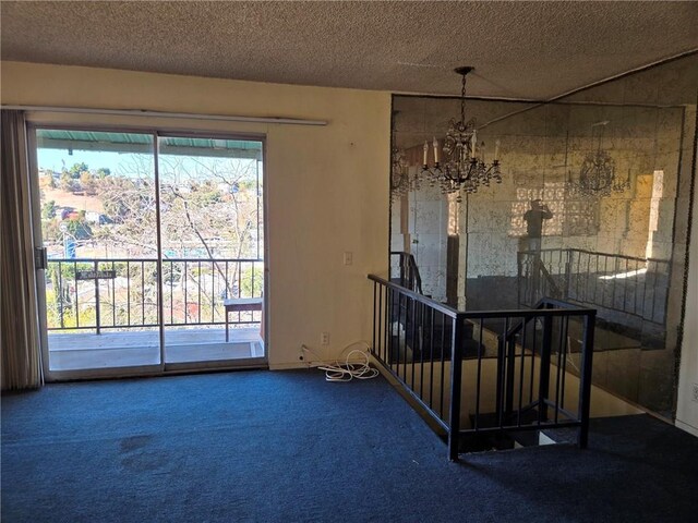 interior space with a textured ceiling, an inviting chandelier, and carpet flooring