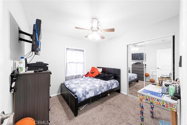 carpeted bedroom featuring ceiling fan and a closet