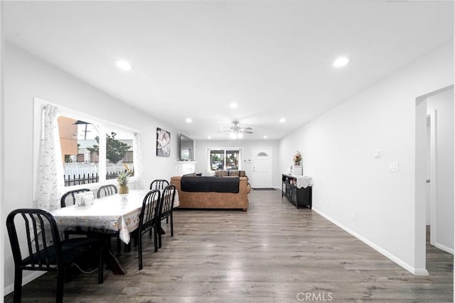 dining room with ceiling fan and dark hardwood / wood-style flooring