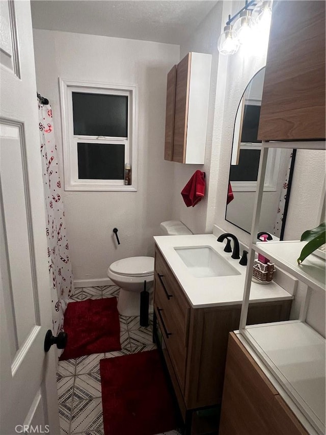 bathroom featuring a shower with curtain, vanity, and toilet