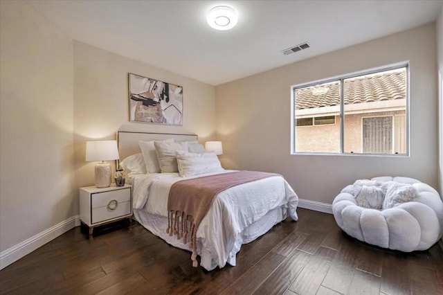 bedroom with dark wood-type flooring