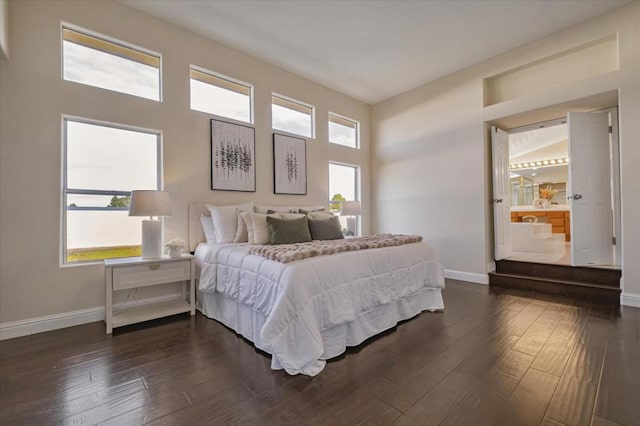 bedroom featuring dark hardwood / wood-style flooring and ensuite bath