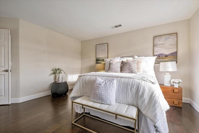 bedroom with dark wood-type flooring