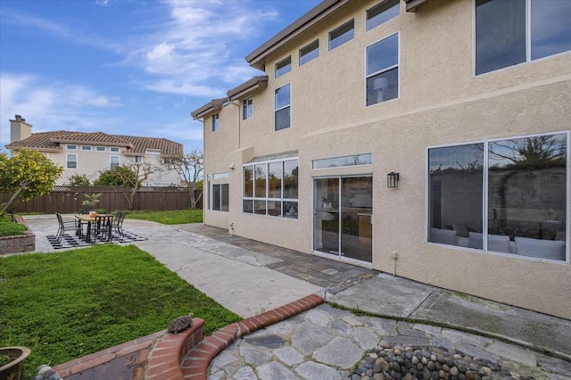 rear view of property with a patio and a yard