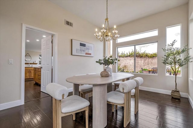 dining space featuring a notable chandelier and dark hardwood / wood-style floors