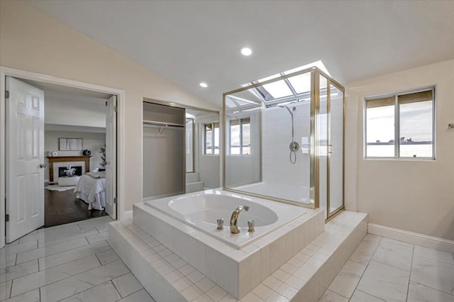 bathroom with lofted ceiling, a wealth of natural light, and separate shower and tub