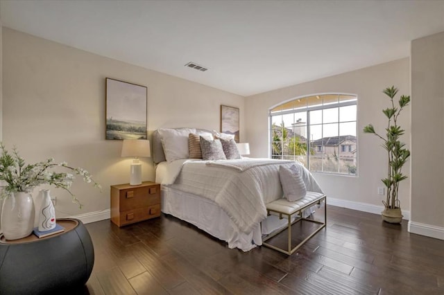 bedroom with dark wood-type flooring