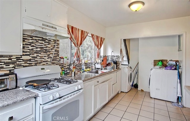 kitchen featuring white cabinets, washer / clothes dryer, sink, white gas range oven, and range hood