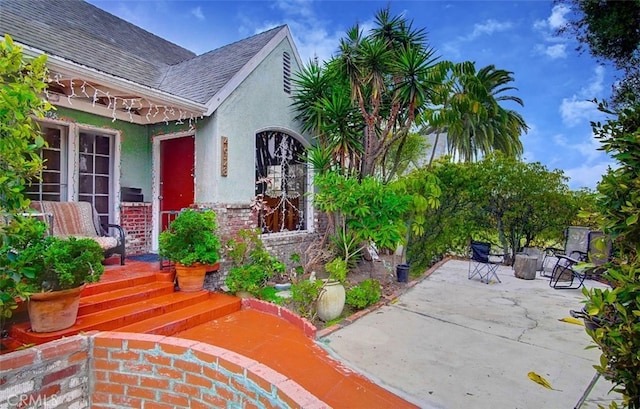 entrance to property featuring a patio area