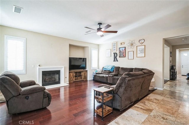 living room with ceiling fan and dark hardwood / wood-style floors