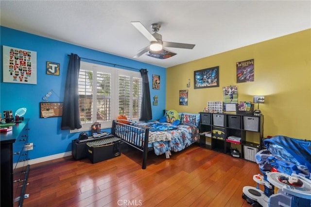 bedroom with ceiling fan and wood-type flooring