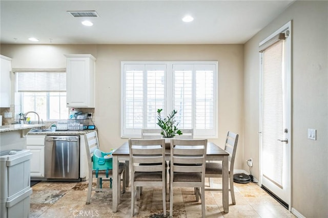 dining space with plenty of natural light and sink