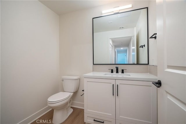 414 Main St Unit 310, Huntington Beach, CA 92647 - bathroom featuring toilet, wood finished floors, vanity, and baseboards