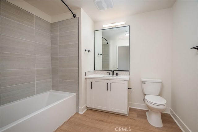 414 Main St Unit 310, Huntington Beach, CA 92647 - full bathroom featuring wood finished floors, toilet, vanity,  shower combination, and baseboards
