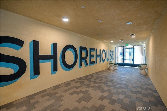 414 Main St Unit 310, Huntington Beach, CA 92647 - corridor featuring recessed lighting, a wall of windows, and a textured wall