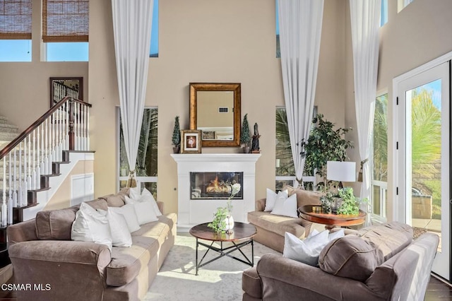 sitting room with a high ceiling and wood-type flooring