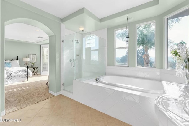 bathroom featuring tile patterned flooring and separate shower and tub