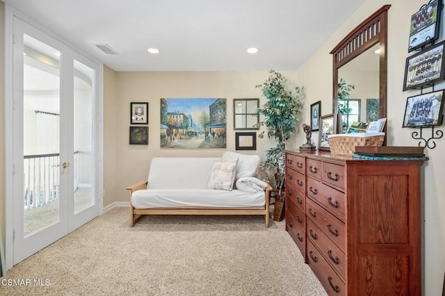 living area featuring light colored carpet and french doors