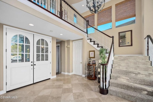 foyer featuring a high ceiling and french doors