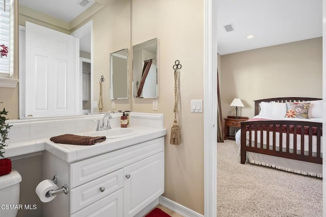 bathroom with toilet and vanity