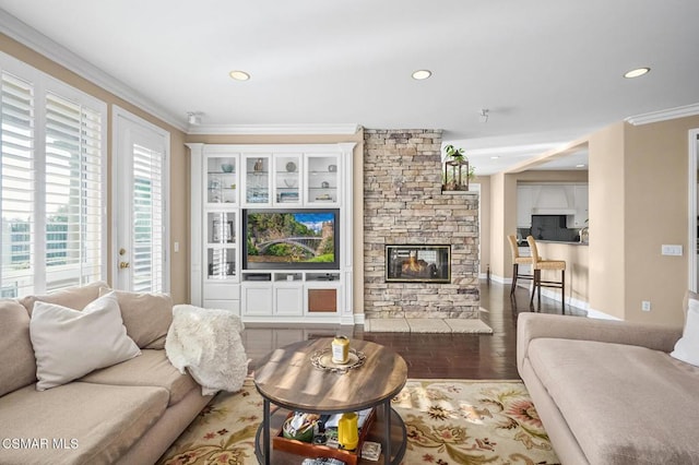 living room with dark hardwood / wood-style floors, crown molding, and a fireplace