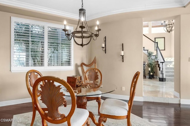 dining space with dark hardwood / wood-style flooring, a chandelier, and ornamental molding