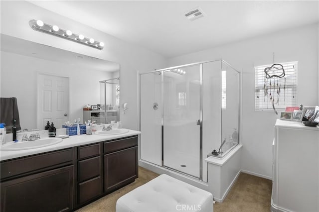 bathroom featuring vanity, washing machine and clothes dryer, and walk in shower