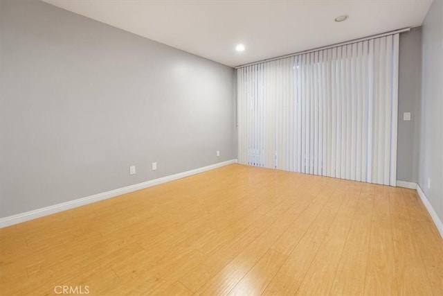 unfurnished room with wood-type flooring