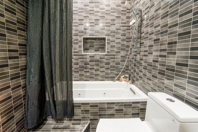 bathroom featuring shower / bath combo with shower curtain, tile walls, and toilet