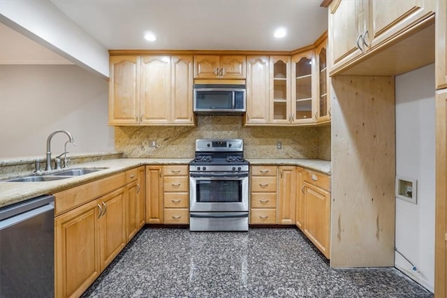 kitchen featuring decorative backsplash, sink, light brown cabinets, and stainless steel appliances