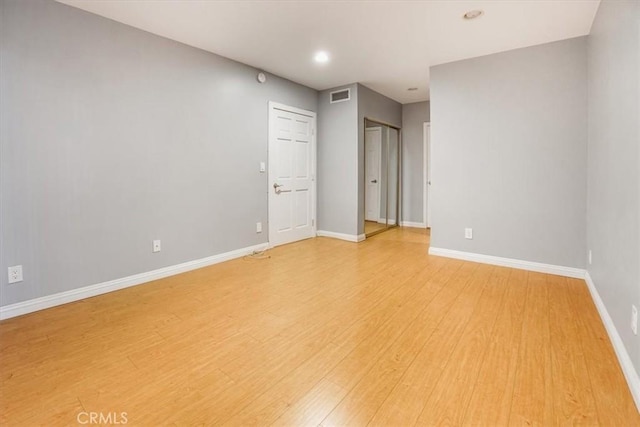 empty room with hardwood / wood-style flooring